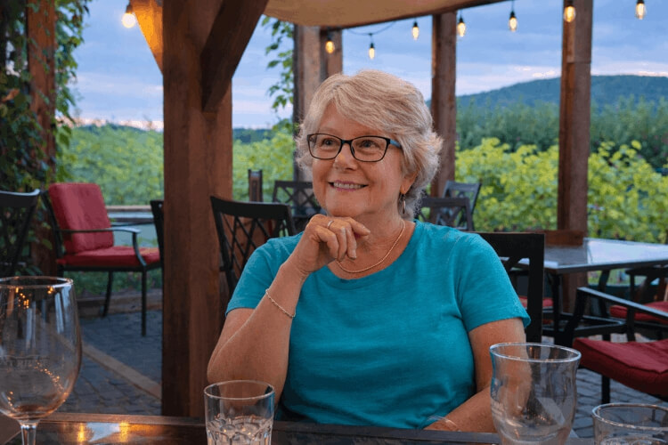Guest enjoying dinner on the patio at Bent Ridge Winery overlooking the countryside near Windsor Nova Scotia